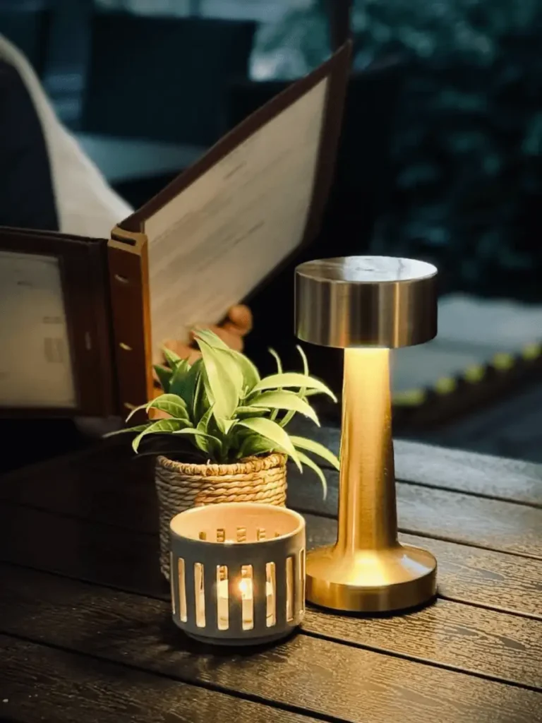 Detail stolu v zahrádce restaurace v Plzni s lampou, svíčkou a dekorací