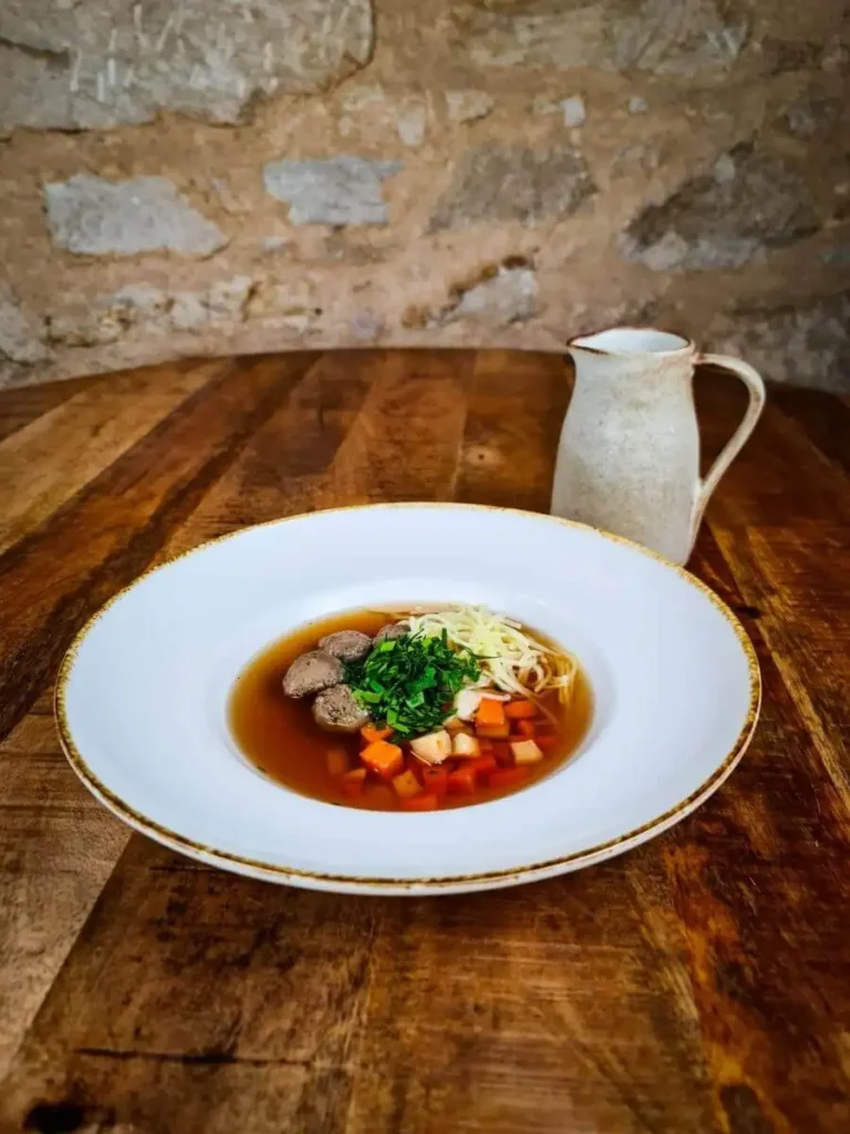 Rich beef broth with liver dumplings, homemade noodles and root vegetables