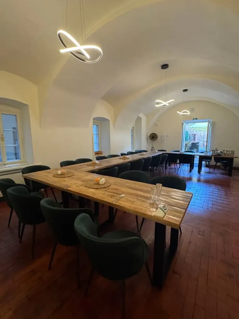 Spacious private lounge in a restaurant in Plzeň with long tables and elegant seating